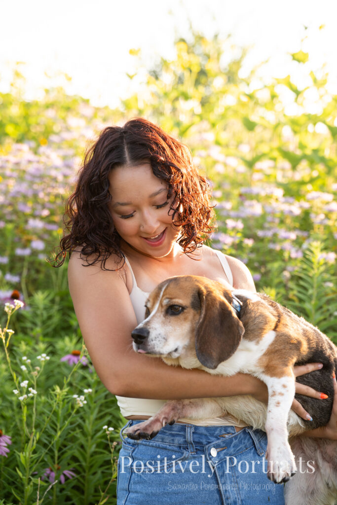 Emerson standing in a field of wildflowers at Brunswick Lake Park, early morning sunlight creating a dreamy glow around her.