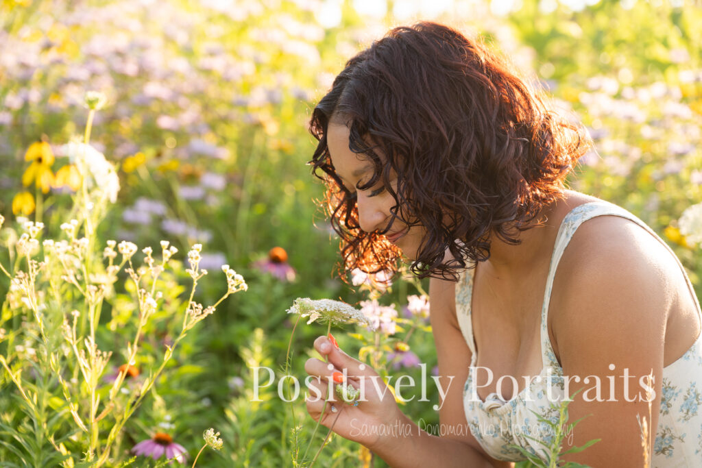 Emerson standing in a field of wildflowers at Brunswick Lake Park, early morning sunlight creating a dreamy glow around her.