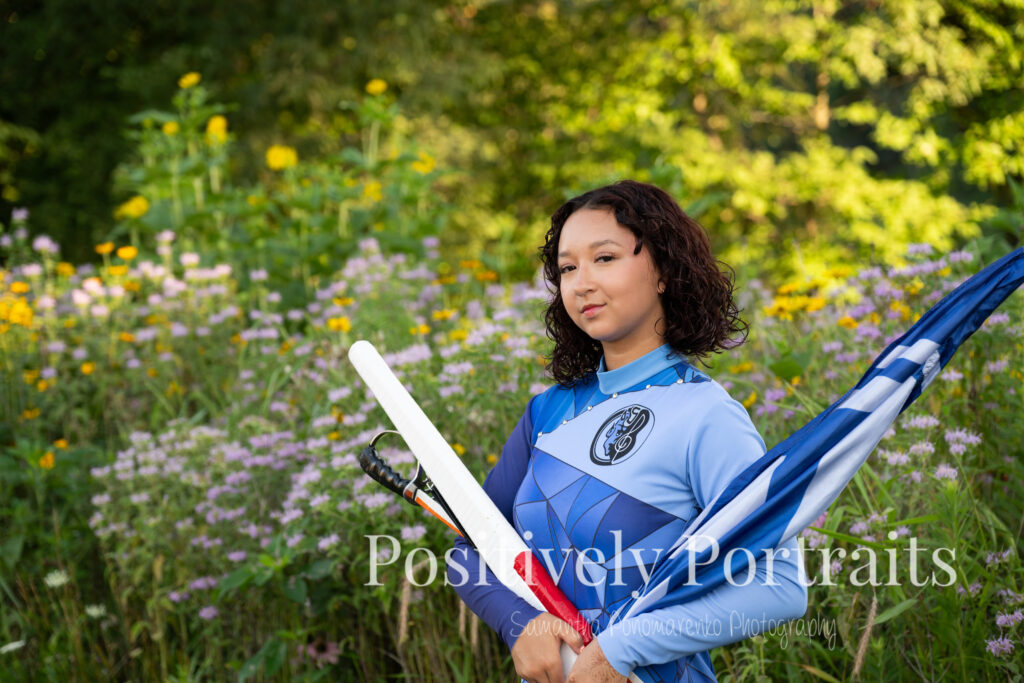 Emerson standing in a field of wildflowers at Brunswick Lake Park, early morning sunlight creating a dreamy glow around her.